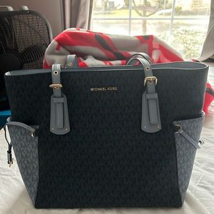 Michael Kors medium size. 12 inches long and 11 inches tall